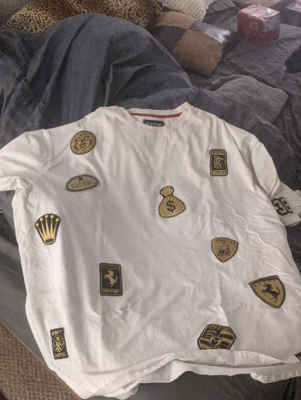 White Makobi Patch t Shirt  - Gold & Black Badges